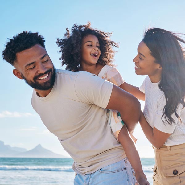 laughing young family at beach