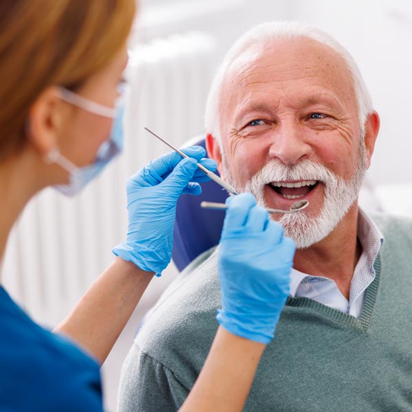 senior man getting dental exam
