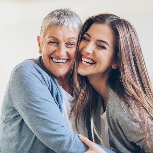smiling mother and adult daughter